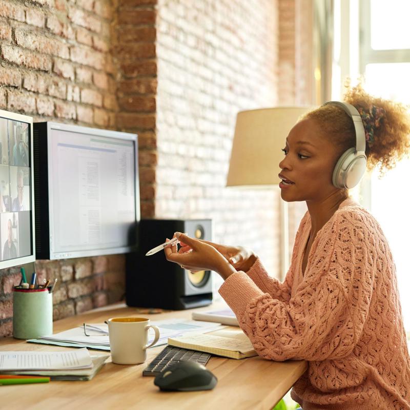 a woman wearing headphones and using a computer