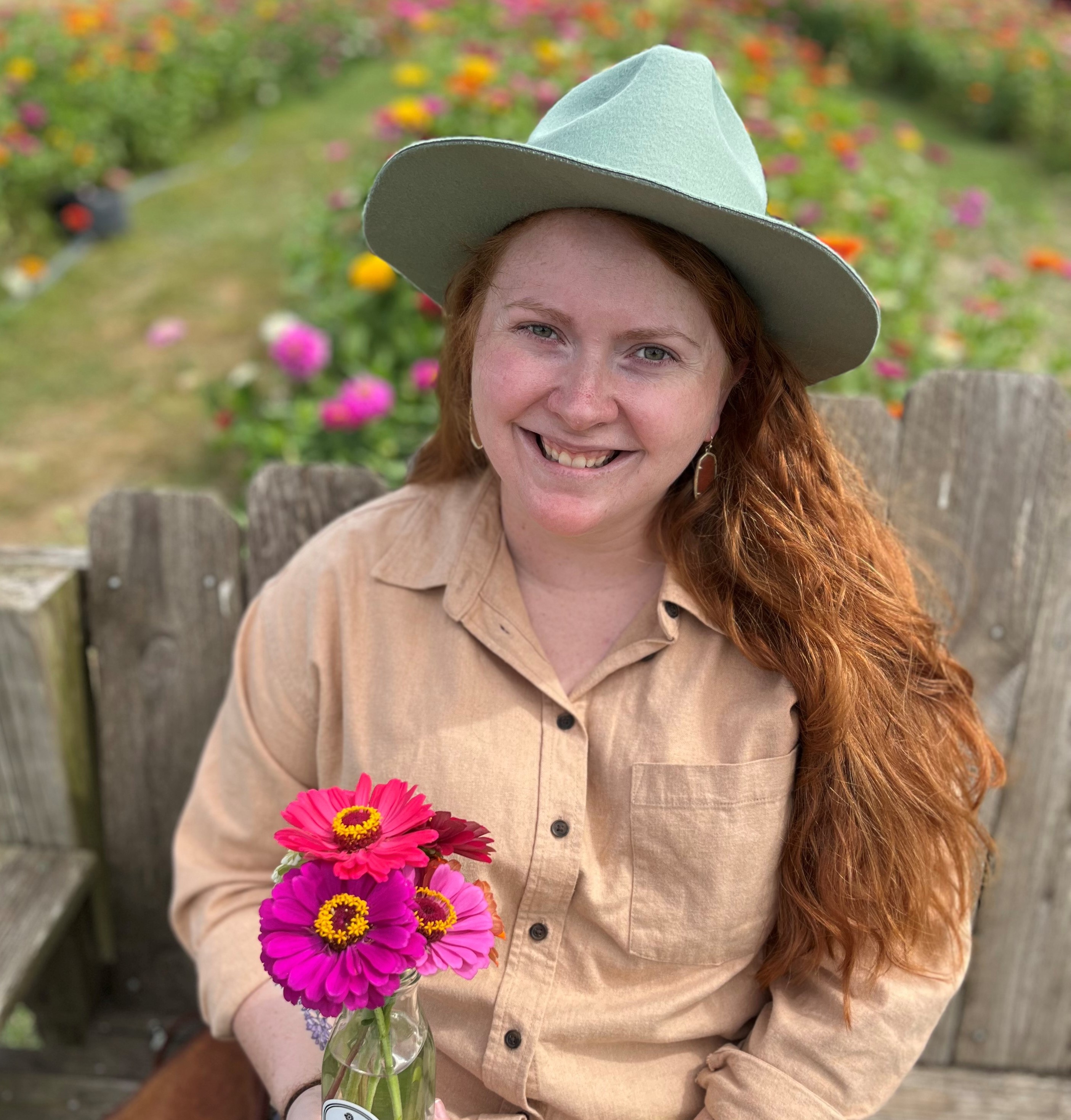 a person sitting on a bench holding flowers
