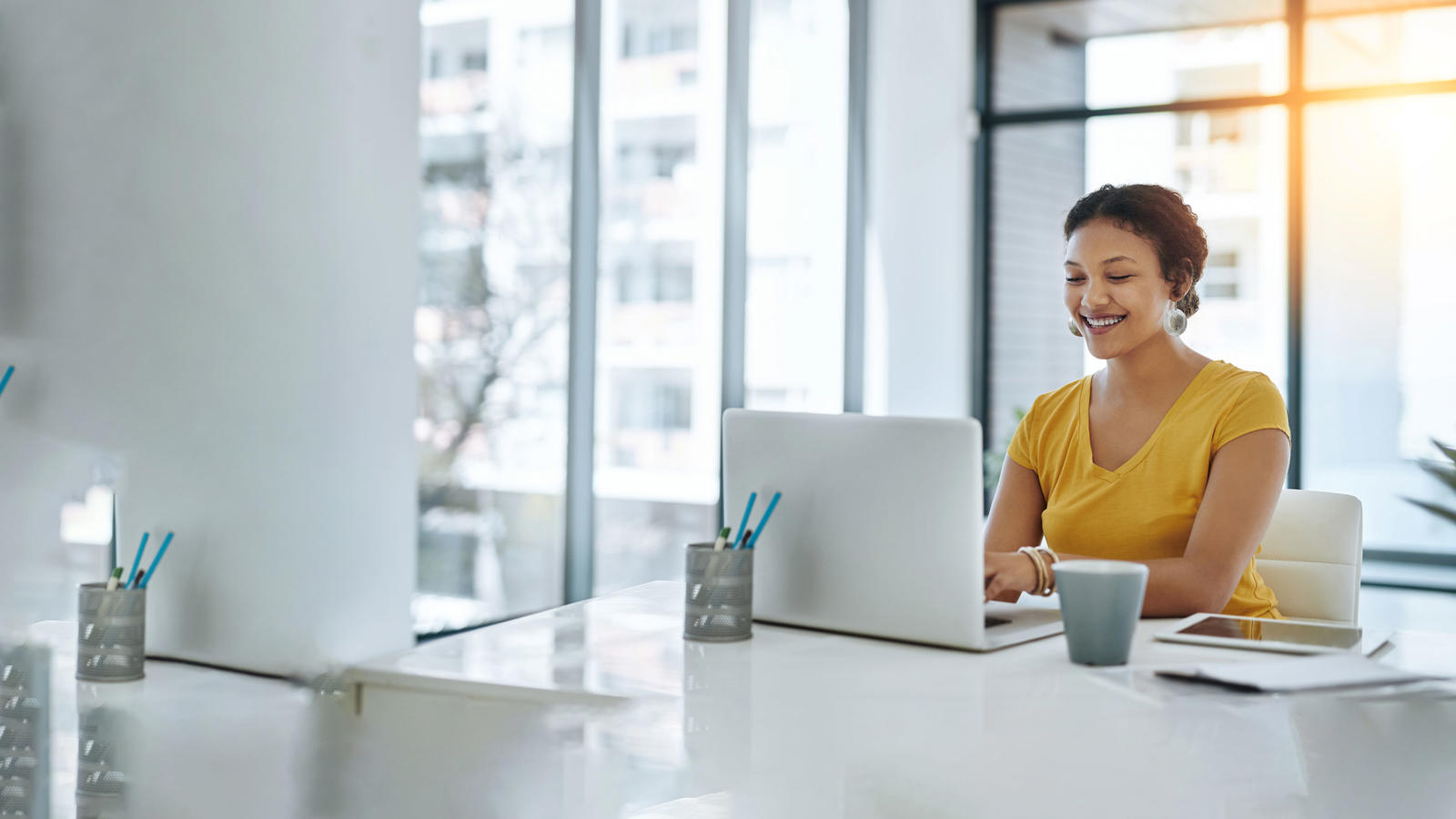 a woman sitting at a desk with a laptop