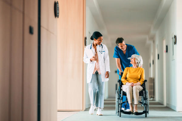 a doctor pushing a person in a wheelchair