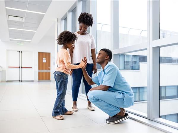 a person and person standing in a hallway with a person and a child