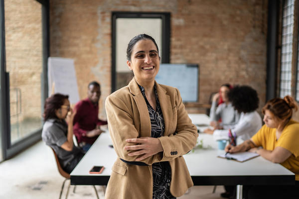 A woman with a sight impairment leads a meeting.