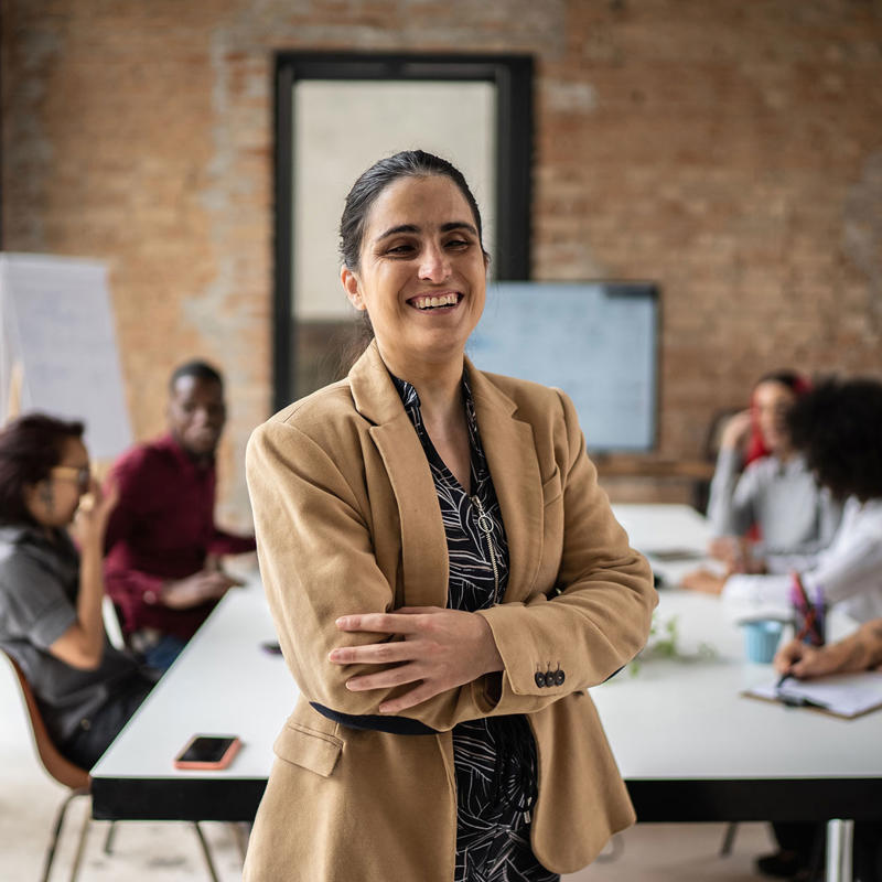A woman with a sight impairment leads a meeting.