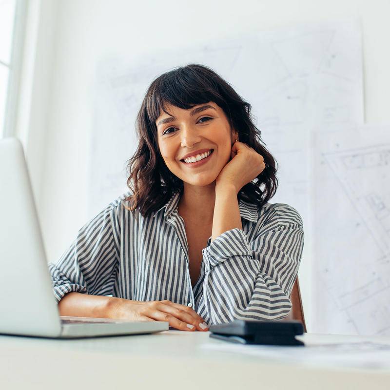 A woman works on her laptop.