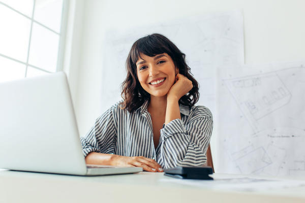 A woman works on her laptop.