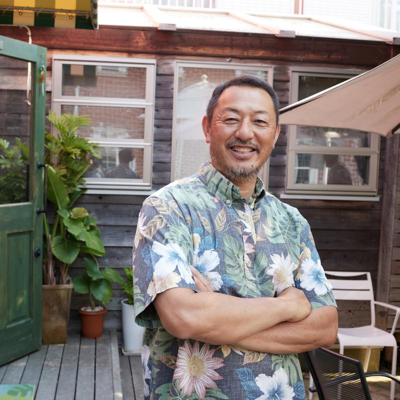 a man standing on a deck with his arms crossed