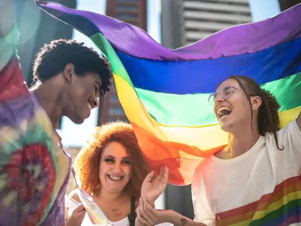 a group of people holding a rainbow flag