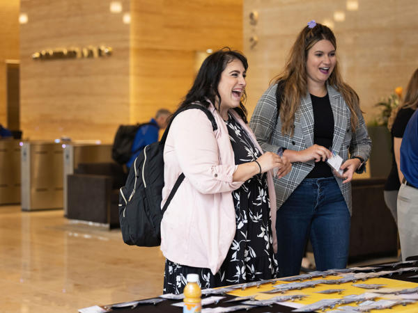 two women standing in a lobby