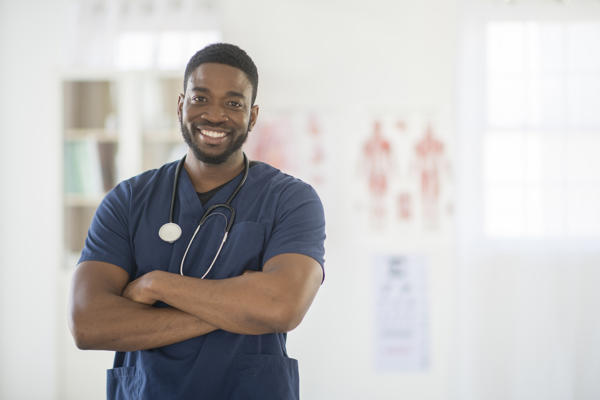 a man in scrubs with stethoscope around his neck