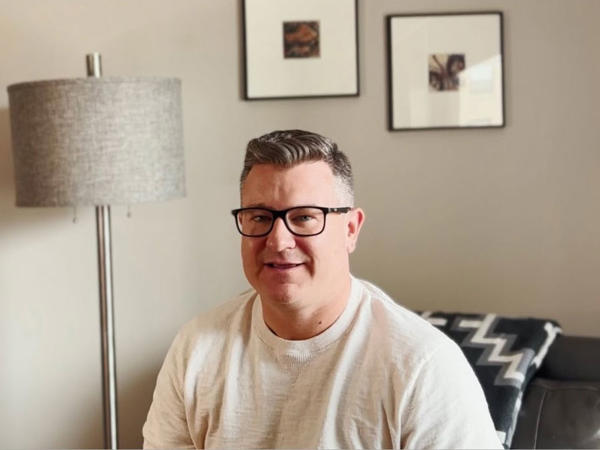 a man wearing glasses and a white shirt