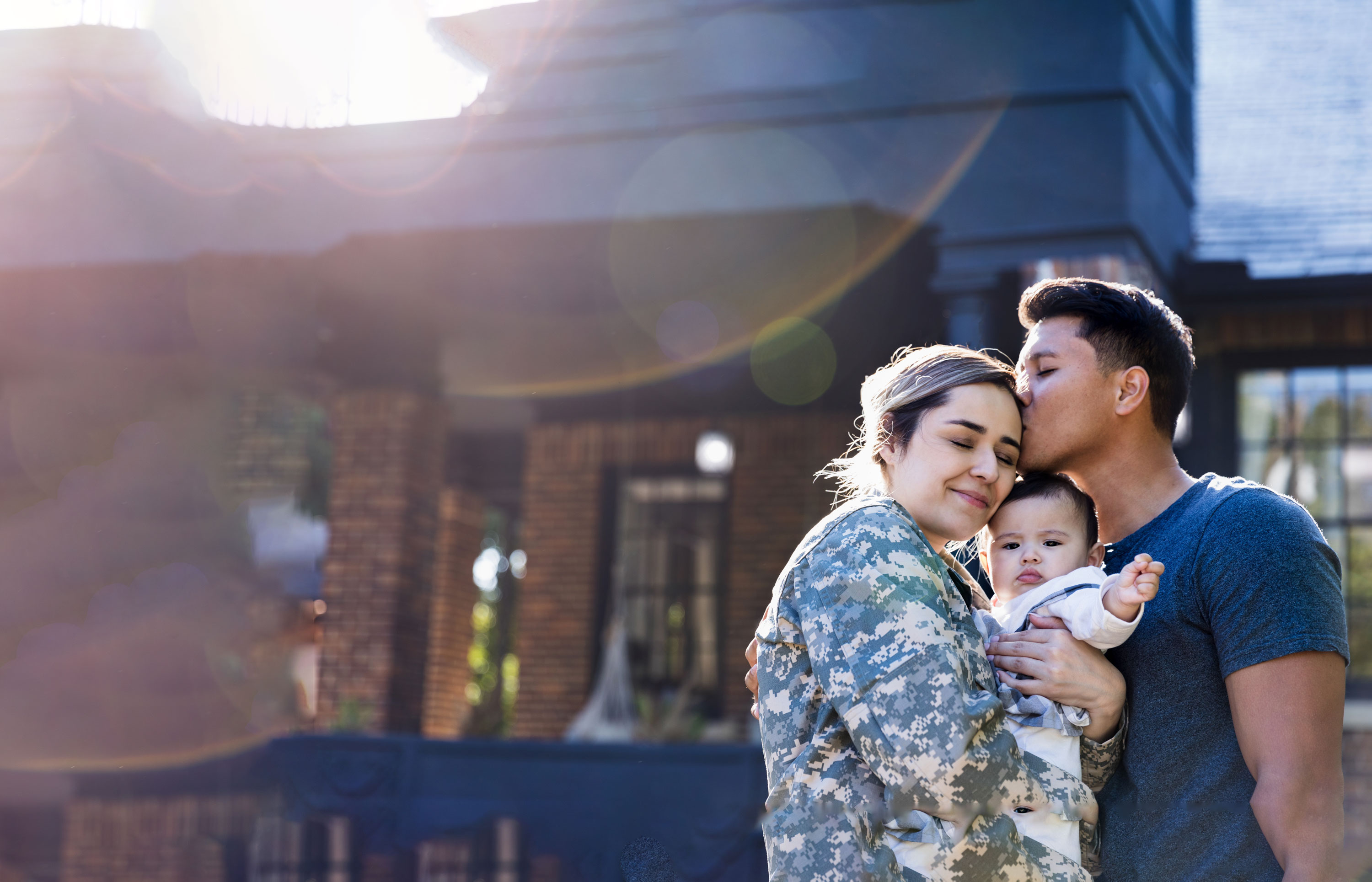 a man kissing a woman in military uniform