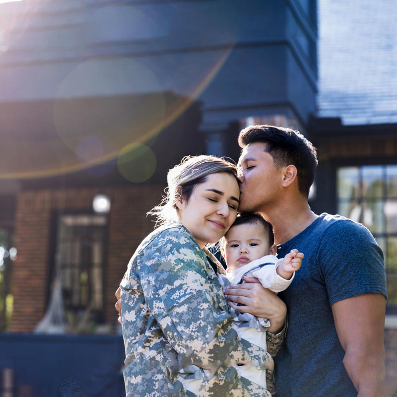 a man kissing a woman in military uniform