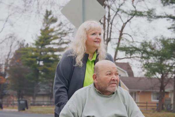 a person pushing a person in a wheelchair