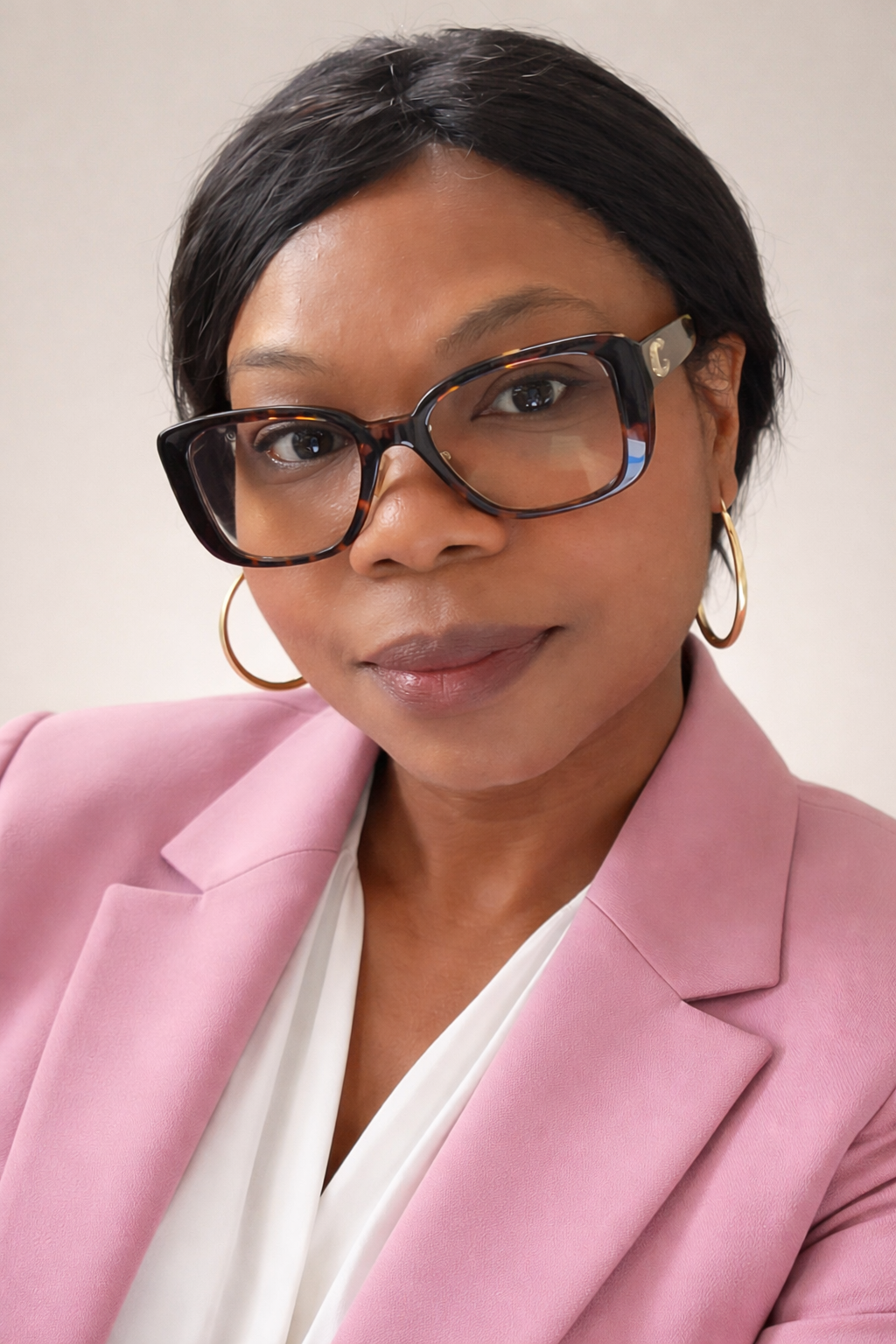a person wearing glasses and a pink jacket