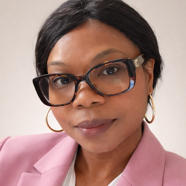 a person wearing glasses and a pink jacket