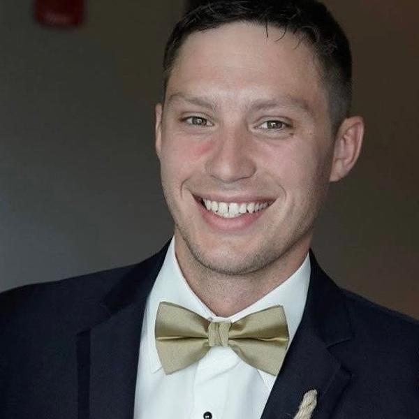 a person in a suit smiling