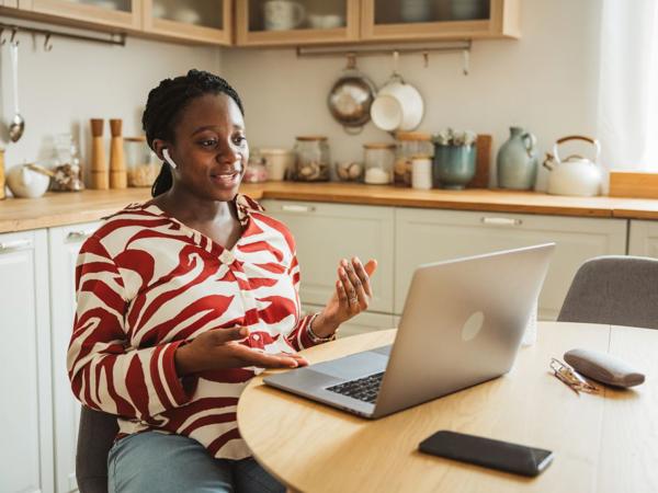 a person sitting at a table with a laptop
