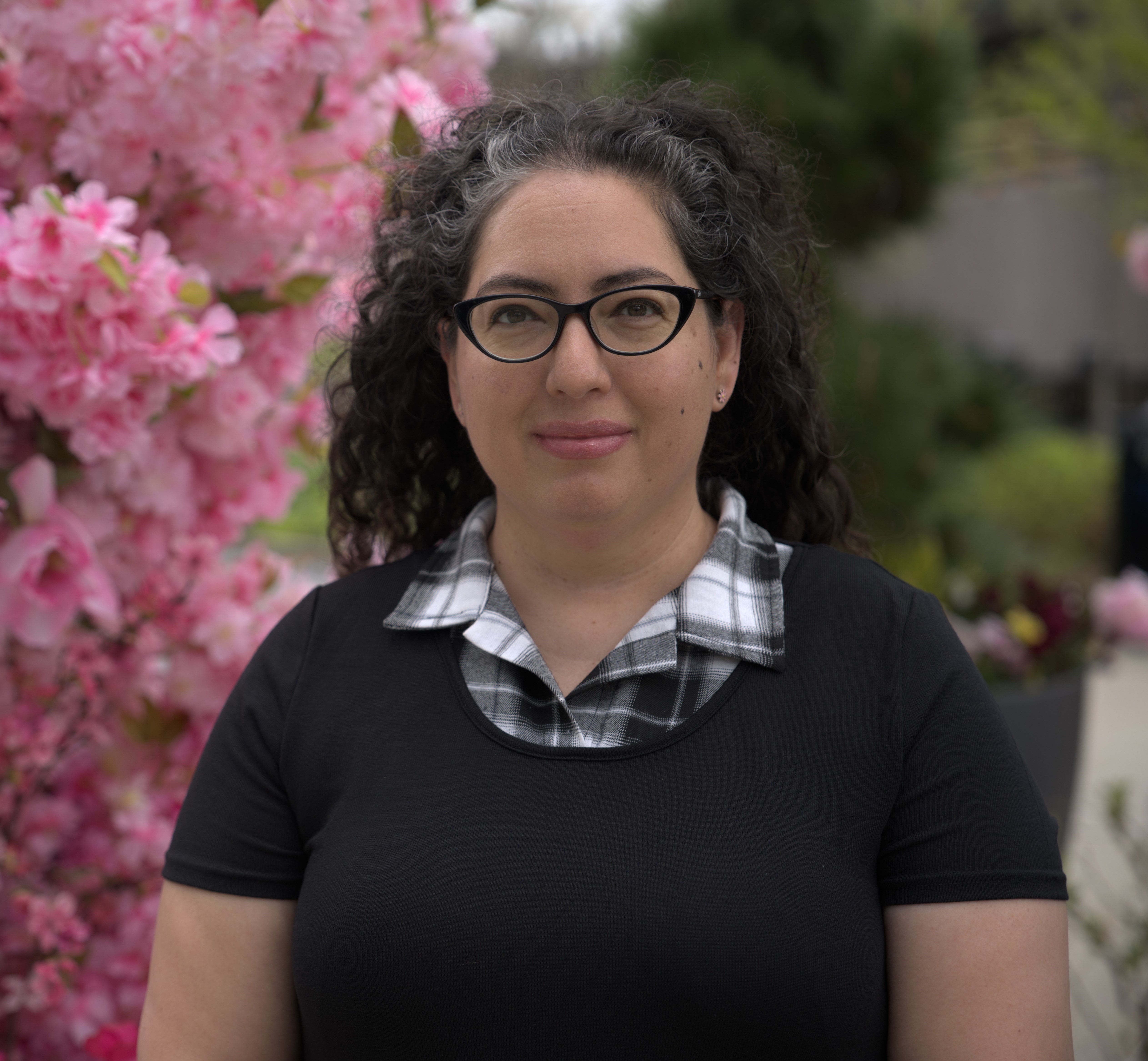 a person with glasses and a black shirt