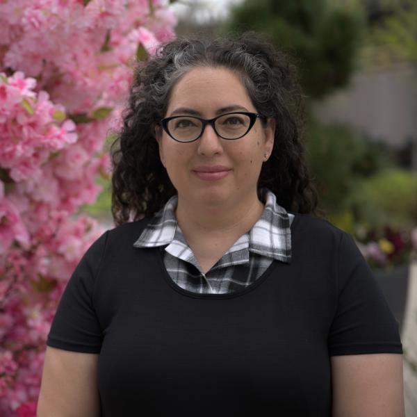 a person with glasses and a black shirt
