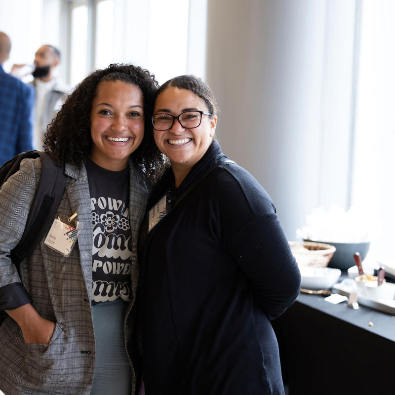 two women smiling at camera