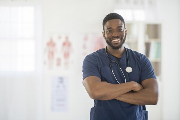 a man wearing scrubs and stethoscope