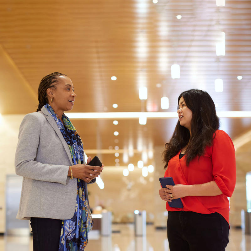 a woman talking to another woman
