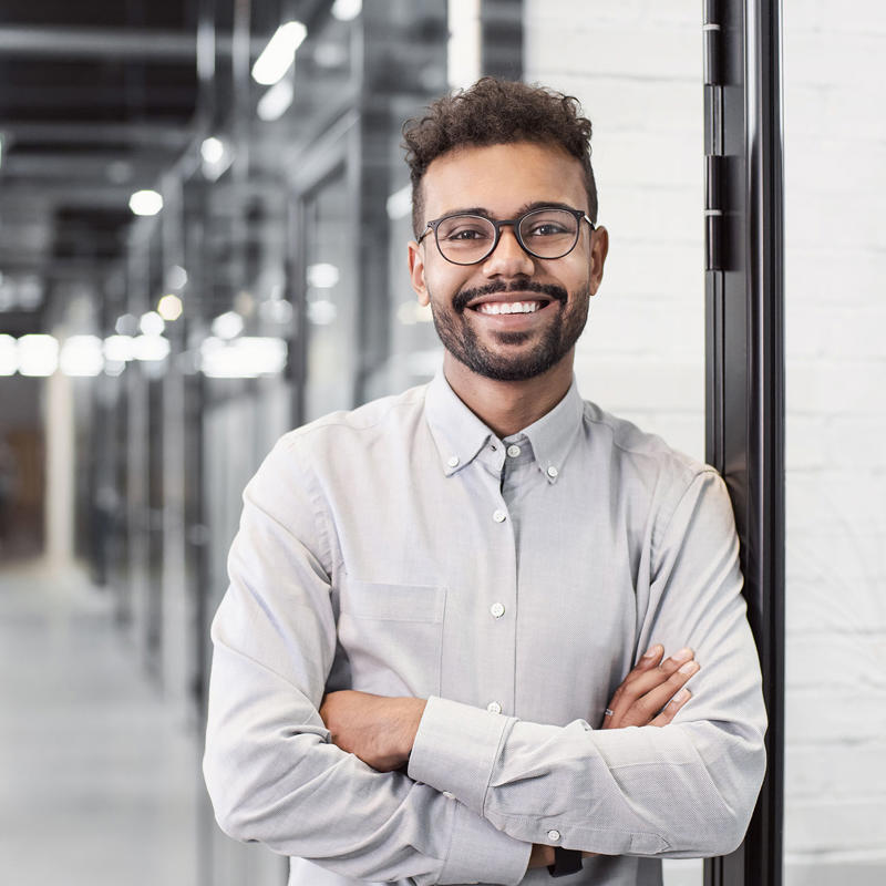a man with glasses and a beard smiling