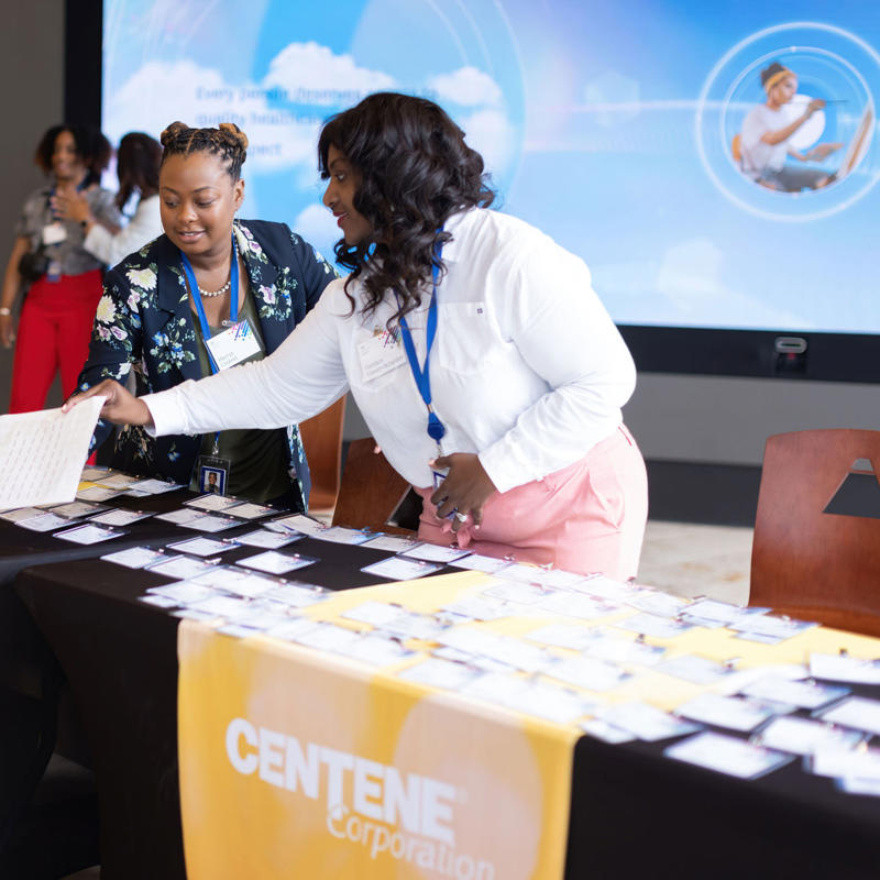 a group of women at a table with brochures