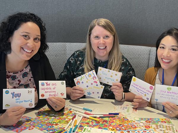 a group of women holding cards